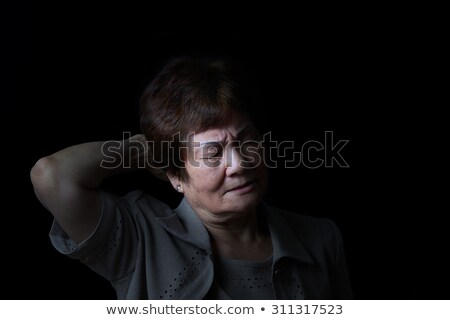 Senior Woman Touching The Back Of Her Head While In Pain On Blac ストックフォト © tab62