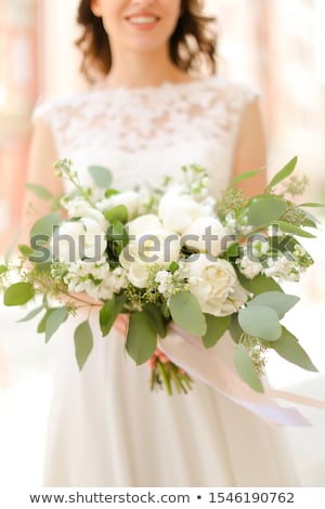 Stock photo: Young Pretty Bride With Bridal Bouquet Indoors