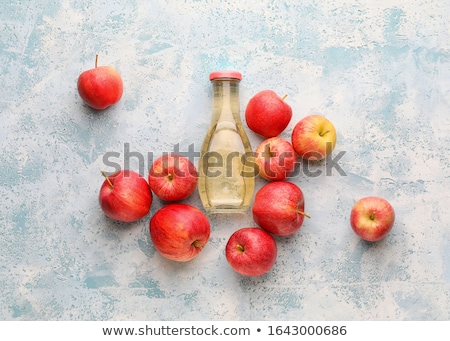 Stok fotoğraf: Glass Bottle Of Apple Organic Vinegar On Blue Background