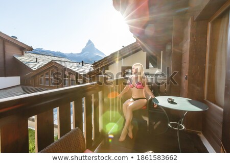 Zdjęcia stock: Silhouette Of Woman In Sunshine At Window With View On Sunset In Mountains
