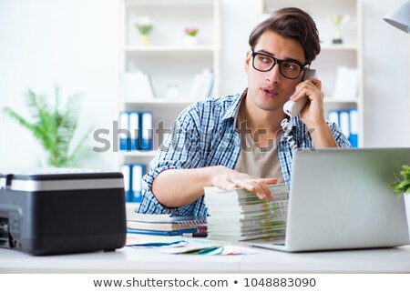 [[stock_photo]]: Sales Assistant At Publishing House Showing Ready Printed Books