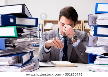 Foto stock: Businessman With Excessive Work Paperwork Working In Office