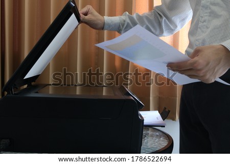 Stok fotoğraf: Hand Holding Paper Copy Printer Machine