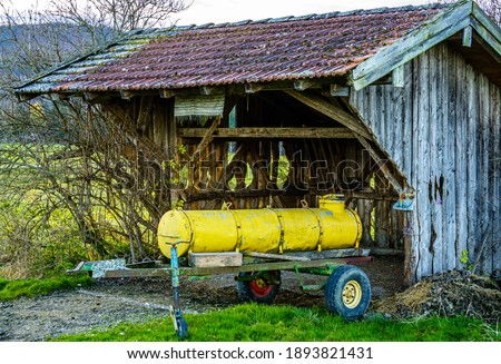 Stok fotoğraf: Water Containers On Cart For Cattle In Meadow