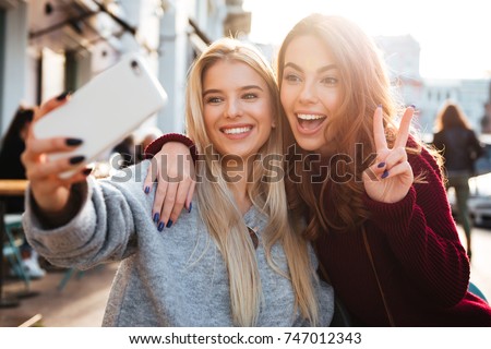 Stock photo: Image Of Beautiful Girls Smiling And Taking Selfie Photo On Cell