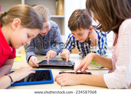 Foto d'archivio: Group Of Happy Children With Tablet Pc At School