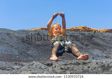 Сток-фото: Boy Has Fun At The Black Volcanic Beach