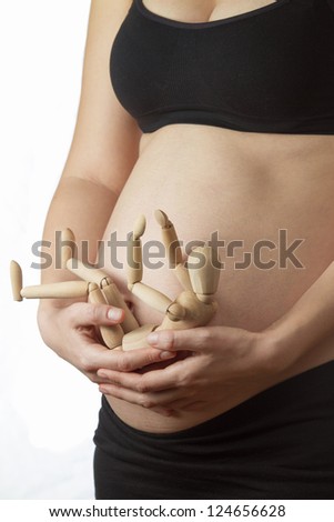 Foto stock: Pregnant Woman Preparing To Be Mom With Wood Dummy