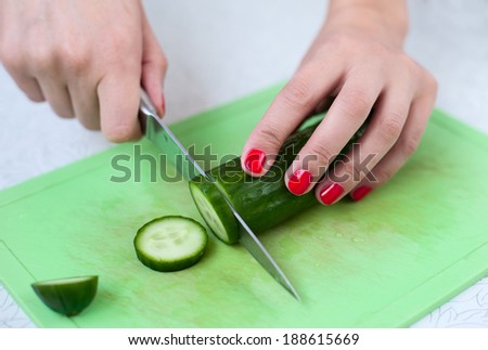 Stock photo: Hand Cuts Cucumber