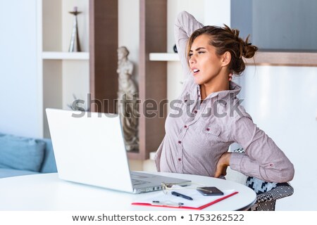 A Woman Sits At A Table In Front Of A Computer And Builds Business Ideas Zdjęcia stock © Photoroyalty