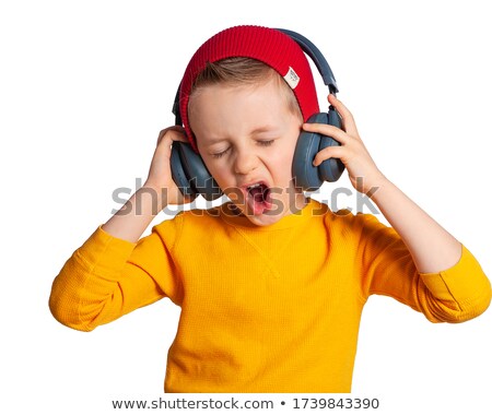 ストックフォト: Portrait Of A Sweet Young Boy Listening To Music On Headphones A