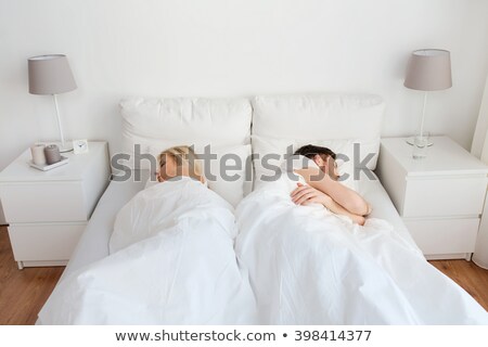 Сток-фото: Couple Lying In Bed Back To Back Having Lovers Quarrel