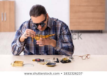 Man With Magnifying Glasses Fixing Watch [[stock_photo]] © Elnur