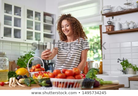 Stock photo: Woman Taking Picture Of Herself With A Mobile Phone