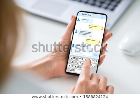 Foto stock: Woman Sending A Text Message