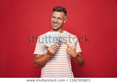 [[stock_photo]]: Image Of Rich Guy In Striped T Shirt Smiling And Holding Fan Of