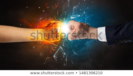 Foto stock: Fighting Hands Breaking Glass With Fire And Water