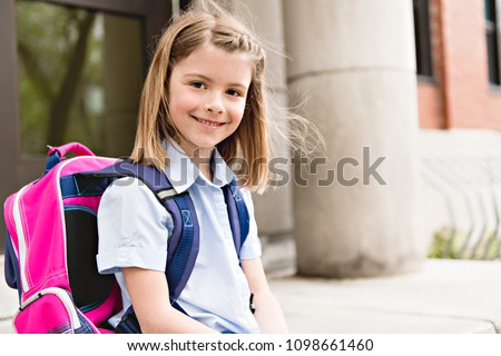 Foto stock: Portrait Of Cute Girl With Backpack Outside Of School