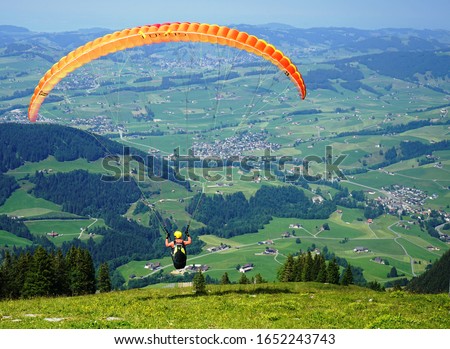 Stock fotó: Paraglider Flies In The Blue Summer Sky