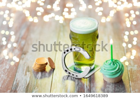ストックフォト: Green Cupcake With Candle Beer And Horseshoe