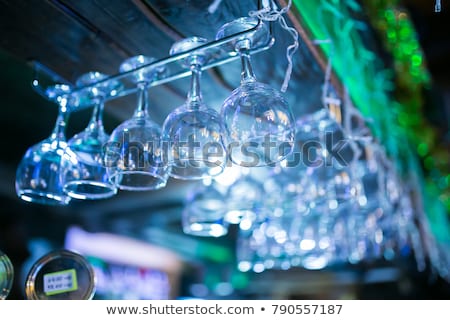 Foto d'archivio: Clean Washed And Polished Glasses Hanging Over A Bar Rack