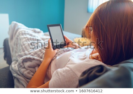 Stock photo: Beautiful Woman In Bed Reading Ebook