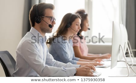 Foto d'archivio: Receptionist With Headset And Side Look Taking A Call