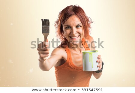 Foto stock: Woman Holding Paint Pot And Brush