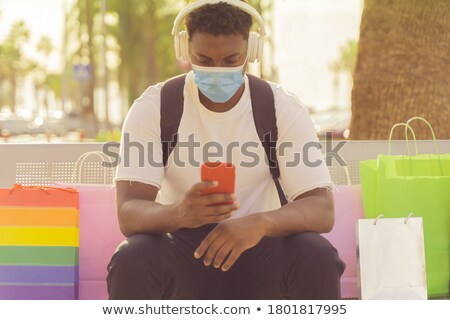 Foto stock: Young Man Listening To Music With Girlfriend By His Side