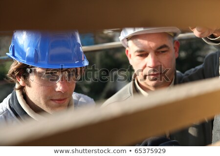 Foto stock: Zinc Worker And Apprentice In Workshop