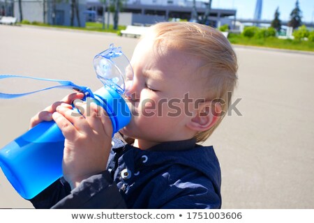 Stok fotoğraf: Young Boy Quenching His Thirst