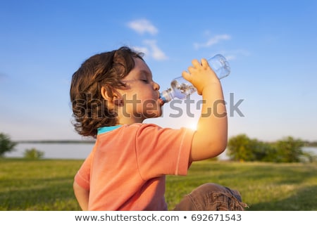 Foto stock: Thirsty Boy Is Drinking Water