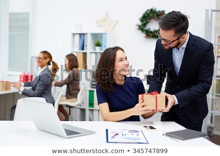 Jeune homme d'affaires donne une boîte avec un cadeau [[stock_photo]] © Pressmaster