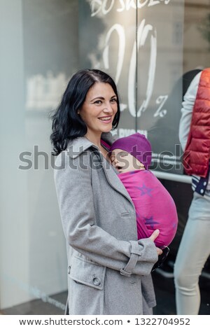 Сток-фото: Woman Carrying Her Baby In Shop