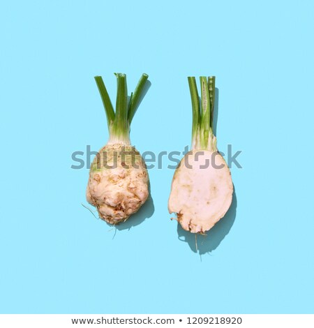 Raw Freshly Ground Parsley Root With Green Stems On A Blue Background With Reflection Of Shadows And Сток-фото © artjazz