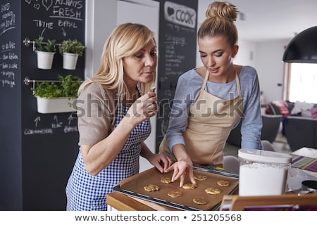 Foto stock: Mother And Daughter Cooking Cupcakes At Home