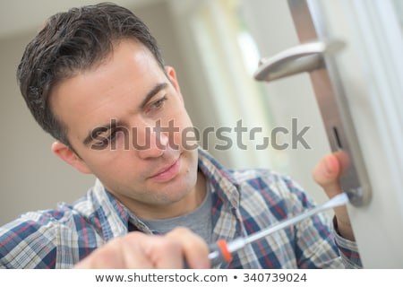 [[stock_photo]]: Handyman Fitting A New Door