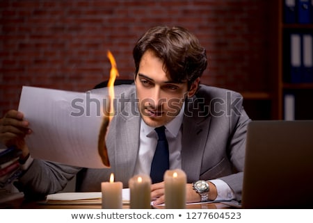 Zdjęcia stock: Businessman Burning The Evidence Late In Office
