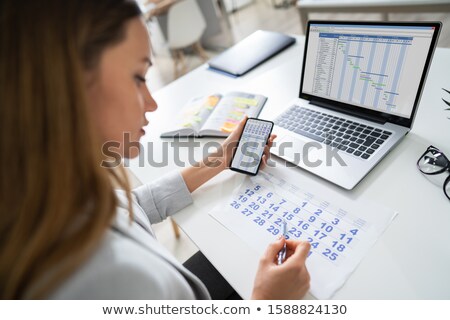 Foto d'archivio: Businesswoman Looking At Calendar On Computer Screen