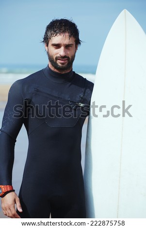 Stock photo: Surfer With His Surfboard Against The Sea