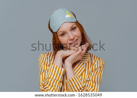 Stok fotoğraf: Portrait Of Good Looking Woman Gets Enough Amount Of Sleep Enjoys Pleasant Relaxation Tilts Head A