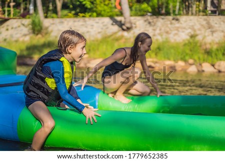 Zdjęcia stock: Man Go Through An Inflatable Obstacle Course In The Pool