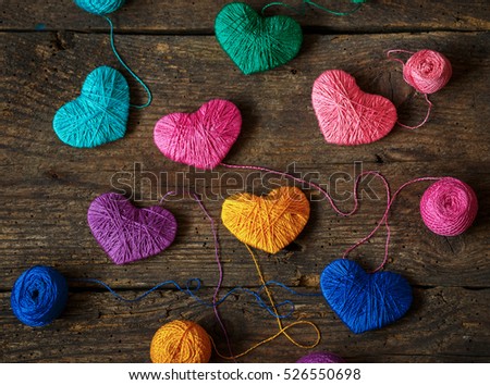 [[stock_photo]]: Purple Heart With A Ball Of Thread On On Old Shabby Wooden Backg