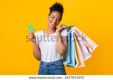 Stock fotó: Smiling Curly Young Lady With Shopping Bags Holding Debit Card