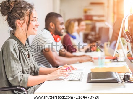 Foto stock: Young Trendy Teamwork Using Computer In Creative Office - Busine