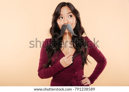 Foto stock: Portrait Of Elegant Asian Female In Pretty Maroon Dress Posing O