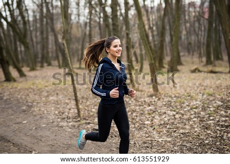 Stockfoto: Young Woman Running Outdoors On A Lovely Sunny Winterfall Day