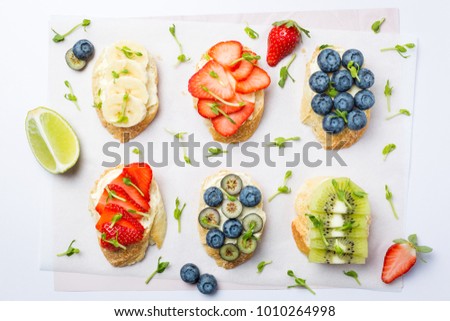 Stok fotoğraf: Fresh Healthy Mini Sandwiches With Cream Cheese Fruits And Berries On Vintage Wooden Board Strawbe