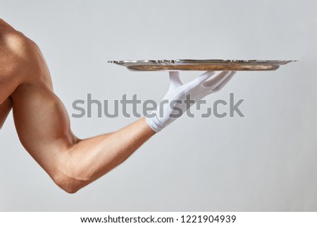 Muscular Hand Of Waiter In A White Glove Holding A Silver Vintage Empty Tray On A White Background Сток-фото © artjazz