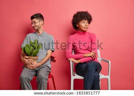 Stock photo: Unhappy Mixed Race Couple Sitting Facing Away From Each Other On